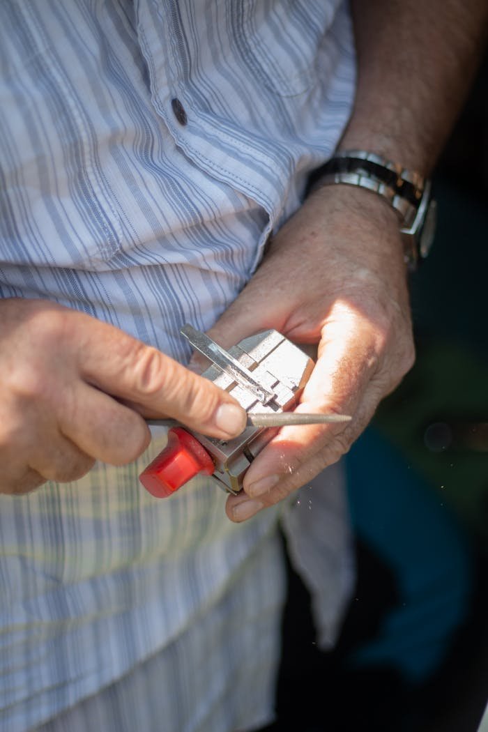 A locksmith using precision tools for detailed metalwork. Suitable for industry and technology themes.